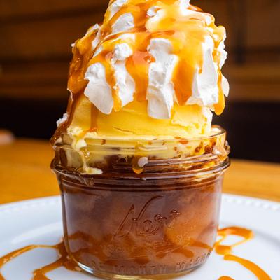 Apple Crisp a La Mode topped with vanilla ice cream.