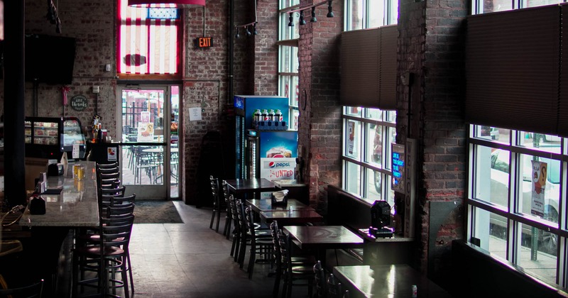 Interior, tables, chairs, bare-brick walls, windows, lighting, decorations, glass doors