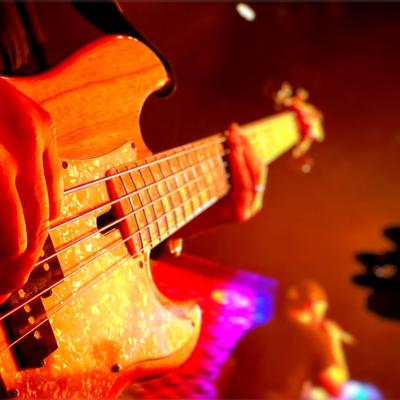 Person playing bass guitar,.