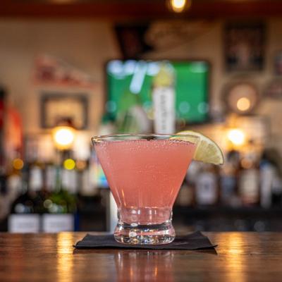 Cosmopolitan cocktail served on the table.