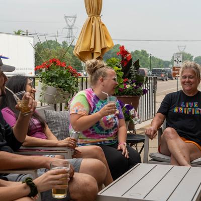 Patio, guests enjoying drinks at a table.