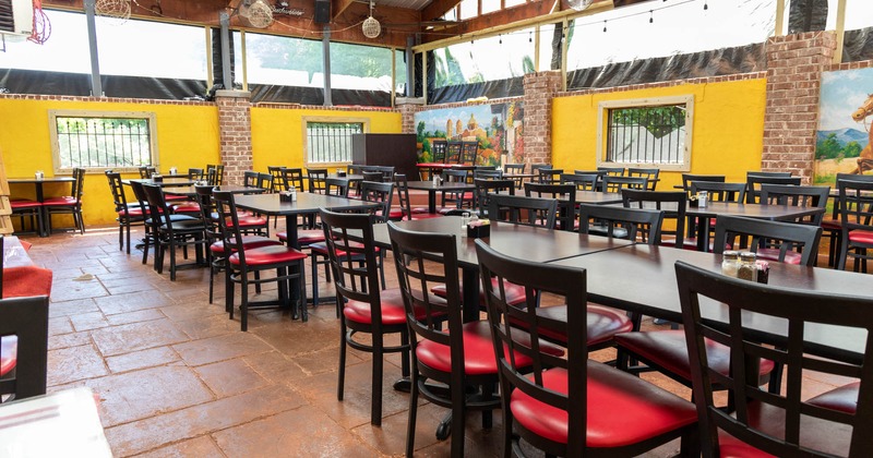 Exterior, covered patio, large seating area, yellow walls, red brick pillars