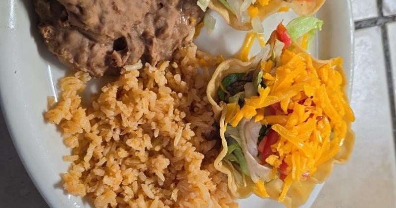 Taco salad with rice and refried beans on a plate