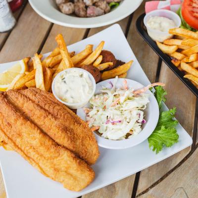 Crispy fried fish fillets served with fries, coleslaw, and tartar sauce.