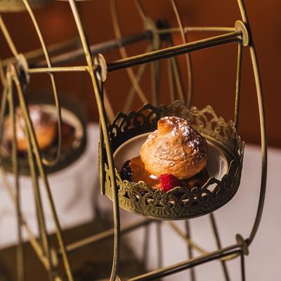 Close-up of a decorative Ferris wheel stand holding small donuts.