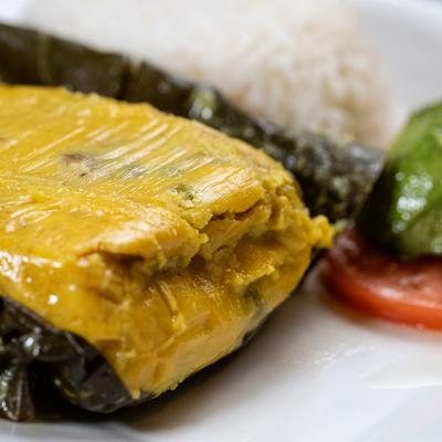 Close-up view of Colombian tamale wrapped in a plantain leaf.