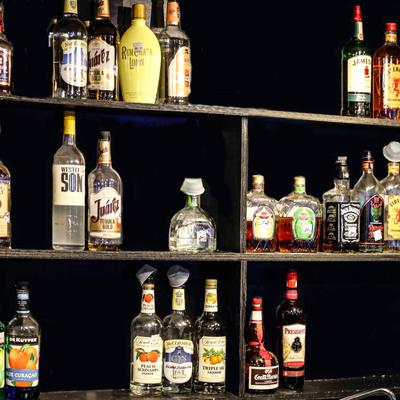 Various liquor bottles on the shelf.