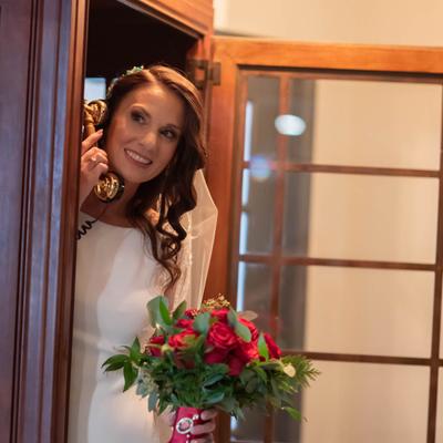 A bride in a phone booth at Ninth Street Event Center.