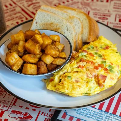 Omelet with home fries and toasted bread.