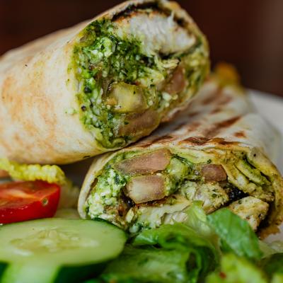 Pesto Chicken Wrap served with fresh salad on the side.