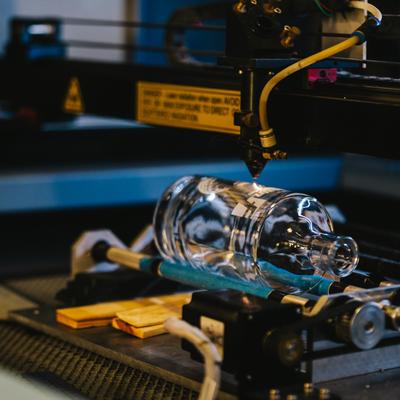 A bottle being stamped.