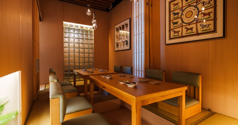 Interior, dining area, wooden tables with padded low seating benches, carpet flooring