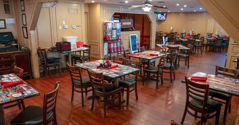 A cozy restaurant dining area with wooden tables and chairs