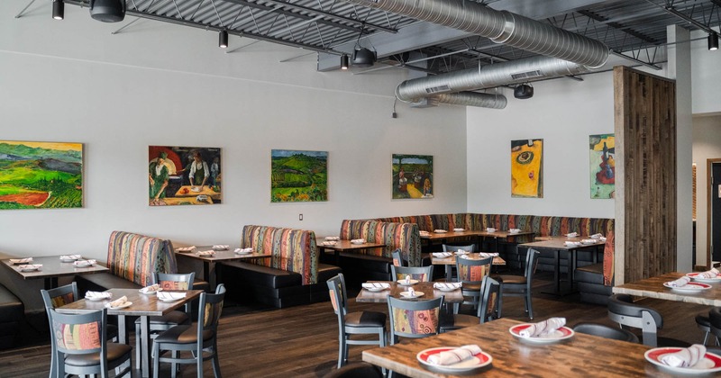 Interior, dining area, tables ready for guests, pictures on the wall