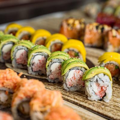 A close-up shot of various sushi rolls neatly arranged on a platter.