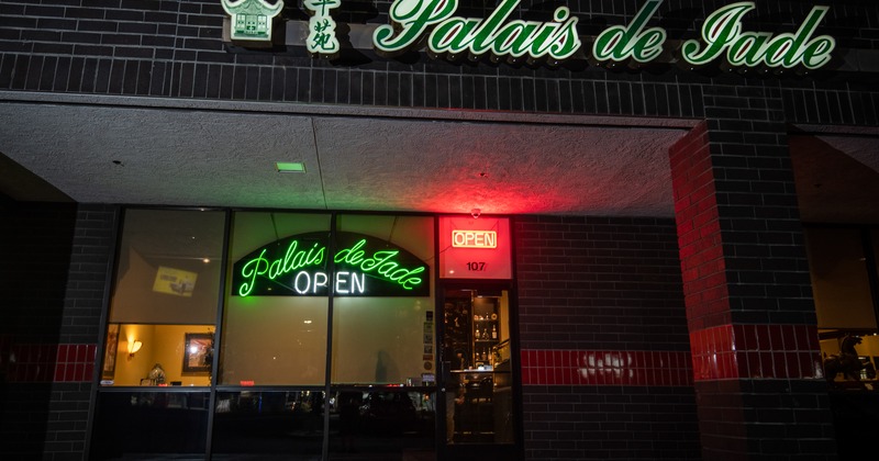 Exterior, front view to restaurant, night photo, light sign above entrance