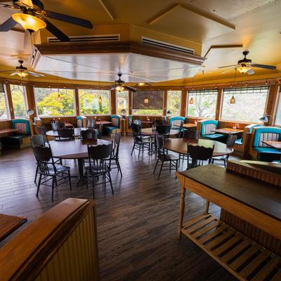 A brightly lit diner interior, with numerous large windows.