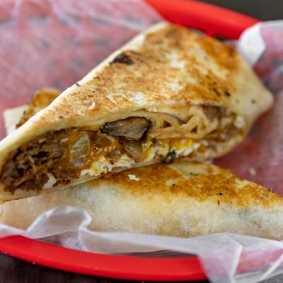 Breakfast Philly Wrap with eggs steak cheese and toppings.