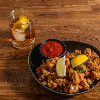 Fried Calamari served with cocktail sauce and Nicoya Old Fashioned.