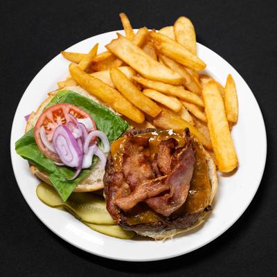 Banquet burger with tomato, lettuce, onion, and pickles, served with fries..
