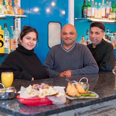Staff members posing for the camera at a bar.