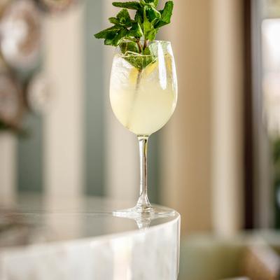 Limoncello spritz with a mint sprig garnish.