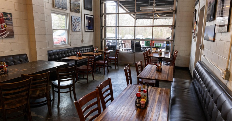 Interior, seating space with leather benches and wooden tables
