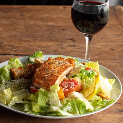 Grilled Salmon Caesar Salad, and a glass of red wine.