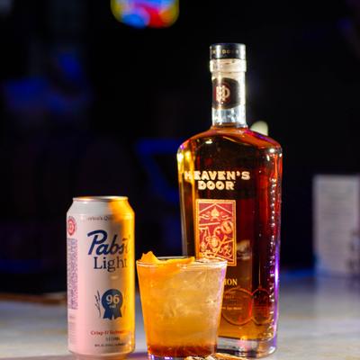 Cocktail, beer, and a bottle of whiskey.