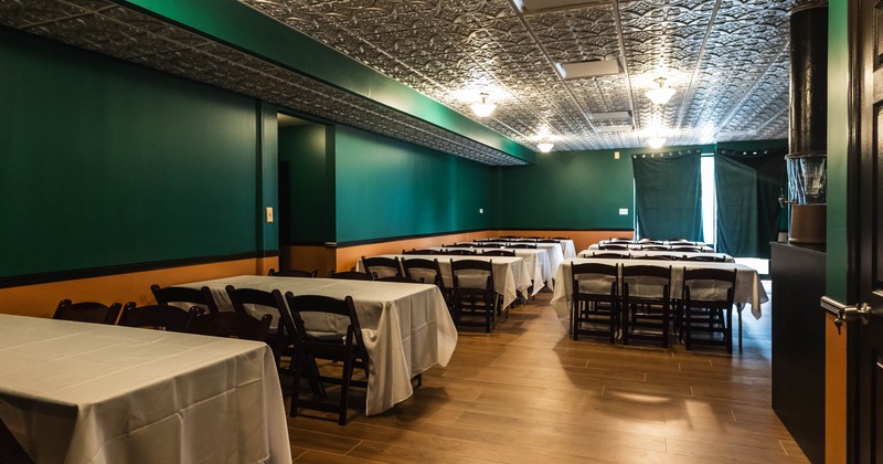 Interior, dining area, white cloth tables for six, tile flooring