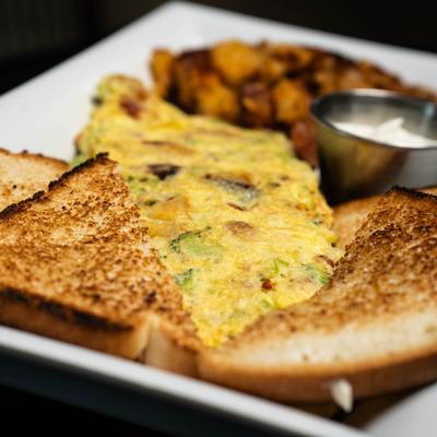 Omlet served with toast, dip and side of roast potatoes.