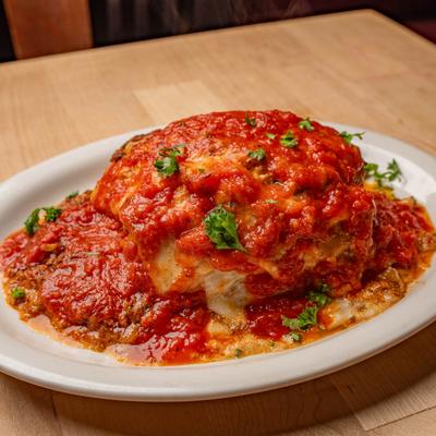 Baked Ziti topped with tomato sauce and green onion.
