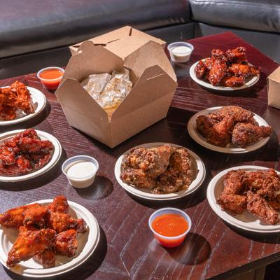 Assorted chicken wings, with dipping sauces.