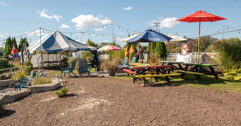 Outdoor seating area with picnic tables and parasols
