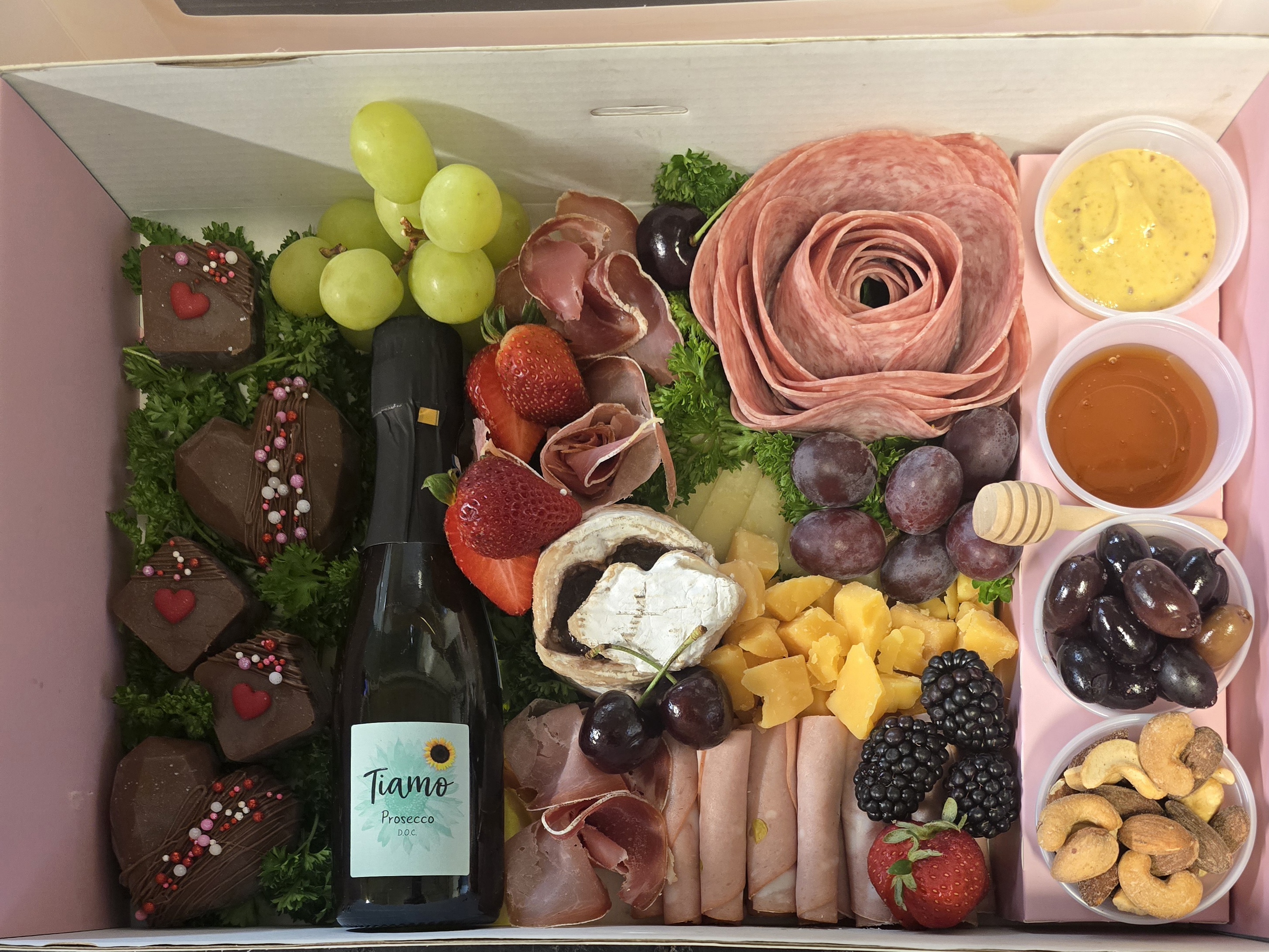 charcuterie gift box with meats, cheeses, condiments, sweets & bubbles