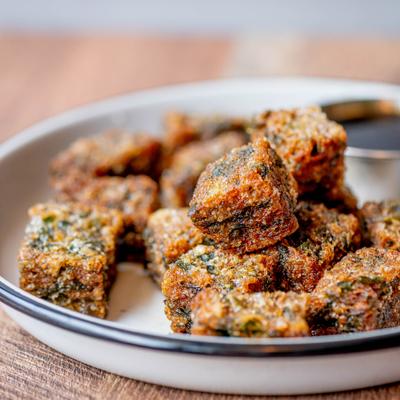 Thai Crispy Garlic Chive Dumplings served with a dipping sauce.