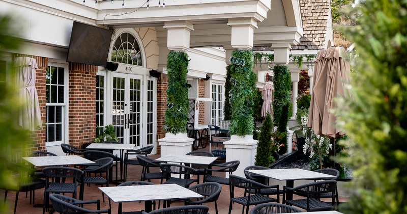 Exterior, patio in front the restaurant, tables, chairs, parasols