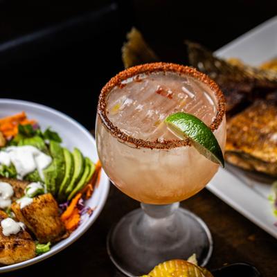 A served margarita and food.