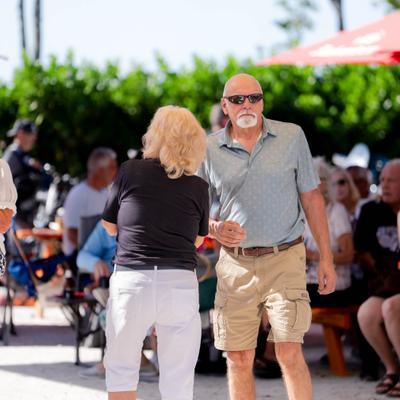 Two people dancing outdoors.