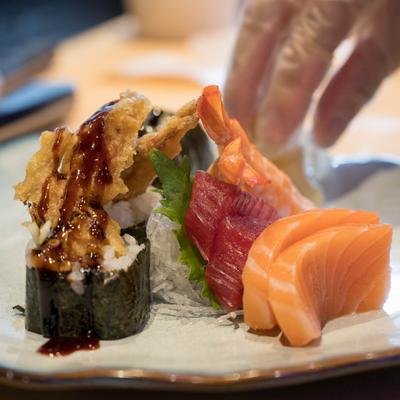 Chef's hand plating a dish.