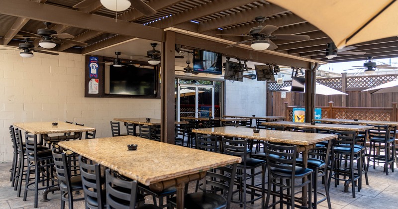 Exterior, covered seating area, high marble top tables with stools