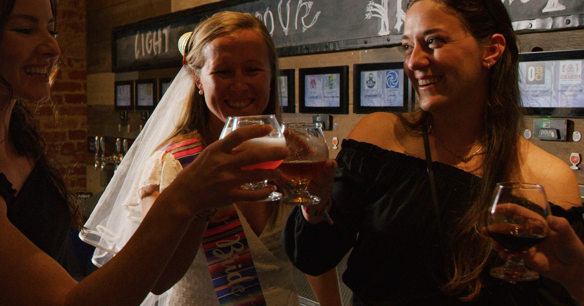 A newlywed making a toast with friends, closeup