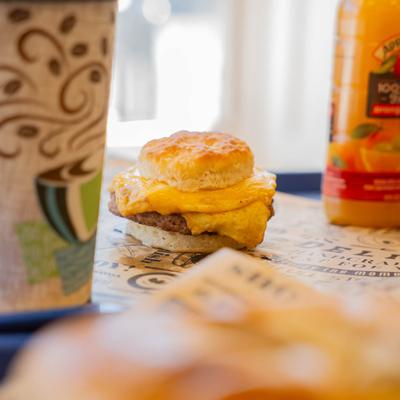 Biscuit sandwich with sausage patty, egg, and cheese.