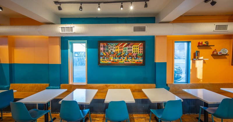 Interior, wooden benches with back, tables and blue chairs lined up