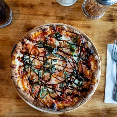 Henry's Pizza with mozzarela, basil, sweet balsamic glaze and hot honey.