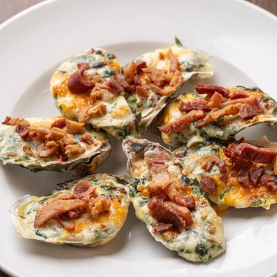 Baked oysters topped with bacon.