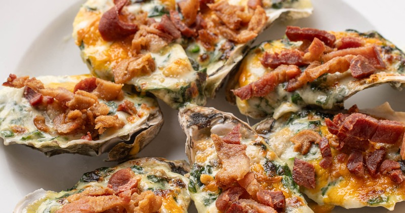 Baked oysters topped with bacon bites
