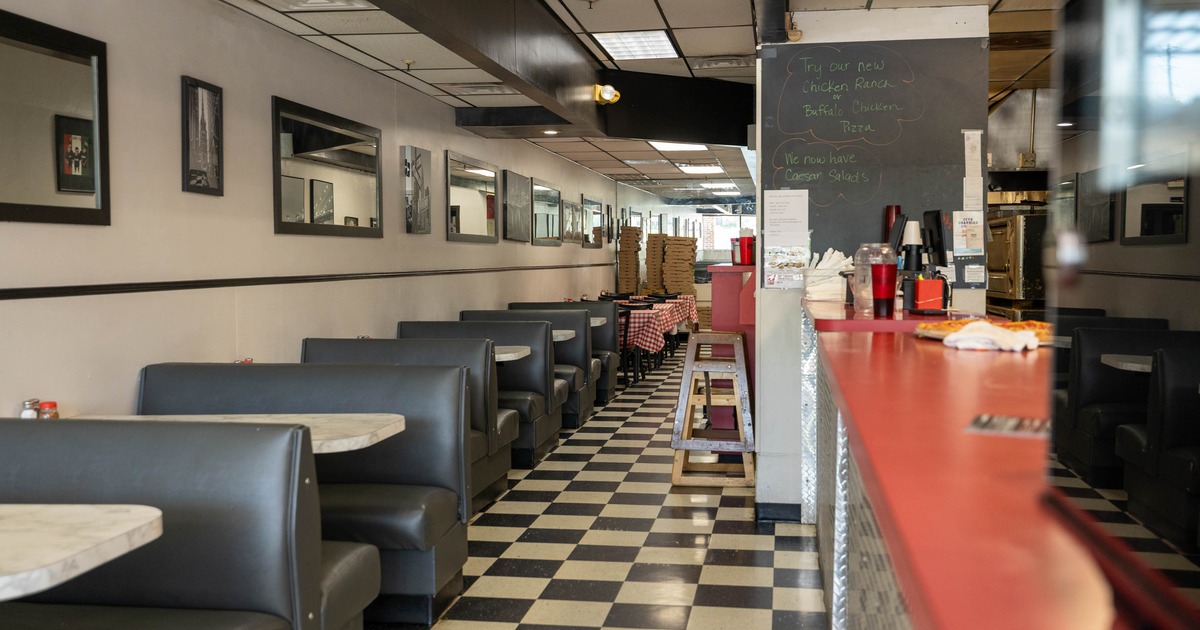 Interior, dining area, seating booths with tables on the left, counter on the right