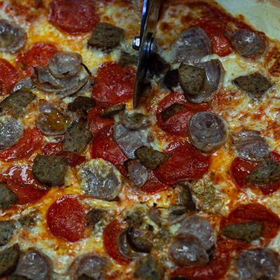 Pepperoni and sausage pizza, close-up.