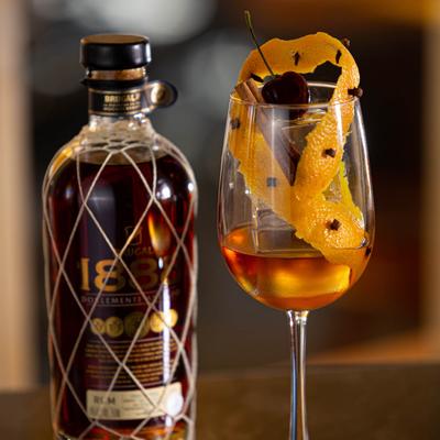 A bottle of rum and a glass of cocktail drink